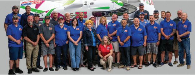 Tri-City Water Follies board members and volunteers posed in front of a hydroplane